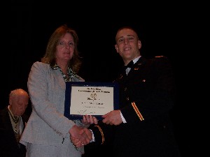 Ruth D. Fleming, chapter president, presents an AFCEA chapter excellence and leadership award to Cadet Mark Kresser, Army ROTC, in April.
